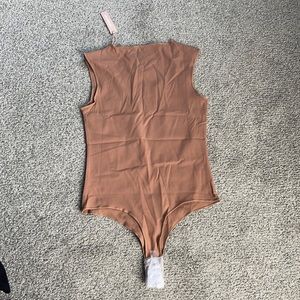 Short sleeve body suit Latte, XS From UNLABELLED, it is still brand new